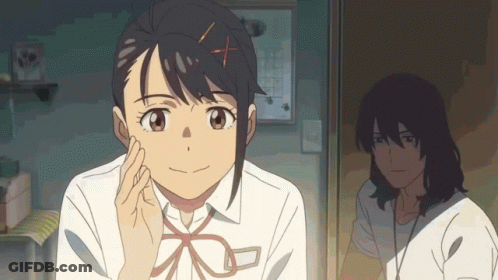 A Girl With An X In Her Hair Is Smiling And Looking At The Camera GIF