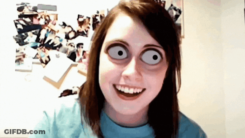 A Girl With Big Eyes And A Blue Shirt Smiles For The Camera GIF
