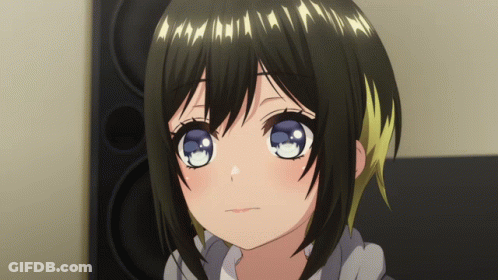 A Girl With Black Hair And Blue Eyes Is Looking At The Camera GIF