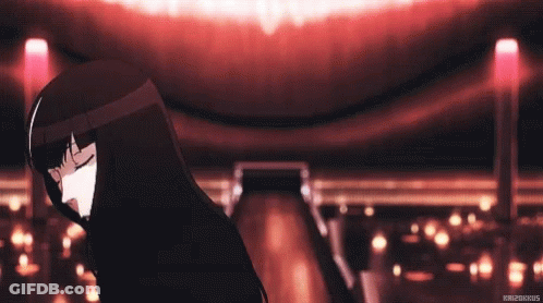A Girl With Black Hair Is Dancing In A Dark Room With Her Eyes Closed . GIF