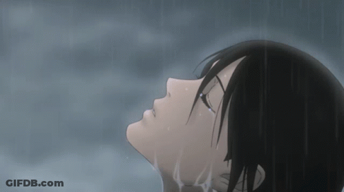 A Girl With Black Hair Is Standing In The Rain With Her Eyes Closed GIF