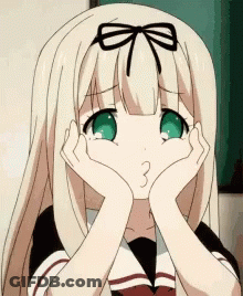 A Girl With Blonde Hair And Green Eyes Is Making A Face With Her Hands On Her Face GIF