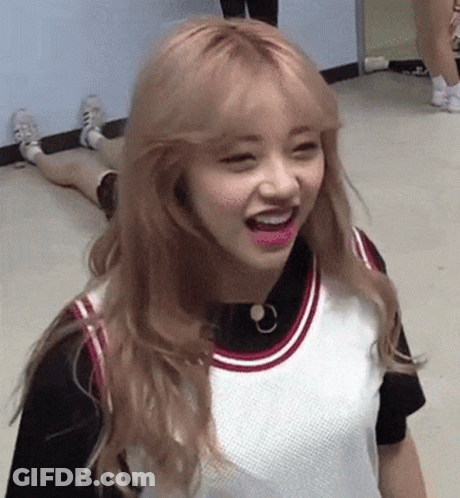 A Girl With Blonde Hair And Pink Lips Is Laying On The Floor . GIF