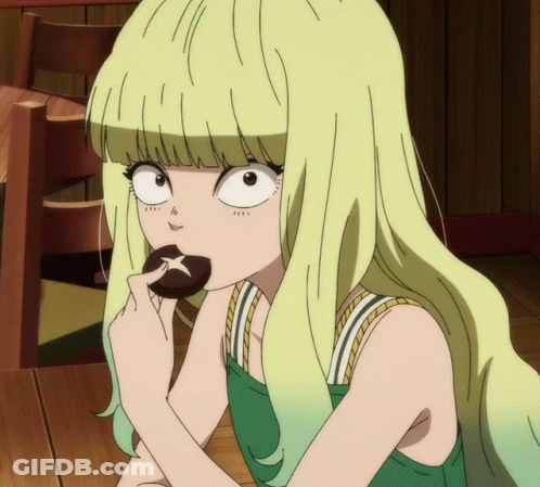 A Girl With Blonde Hair Is Eating A Cookie With A Star On It GIF