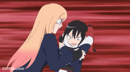 A Girl With Blonde Hair Is Holding A Girl With Black Hair In Her Arms GIF