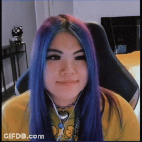 A Girl With Blue And Purple Hair Is Wearing A Yellow Shirt That Says Ds GIF