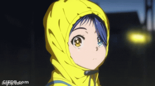 A Girl With Blue Hair And Yellow Eyes Is Wearing A Yellow Jacket With A Hood . GIF