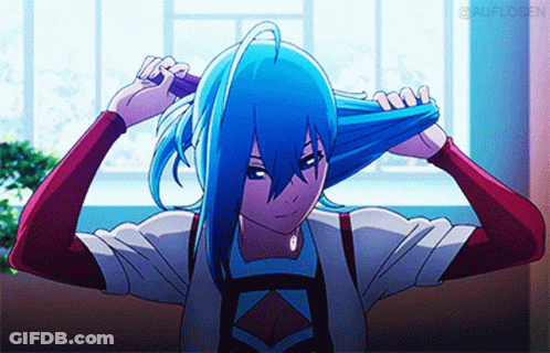 A Girl With Blue Hair Is Brushing Her Hair With A Brush GIF
