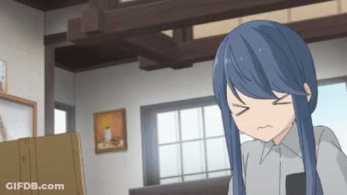 A Girl With Blue Hair Is Making A Funny Face In A Room GIF