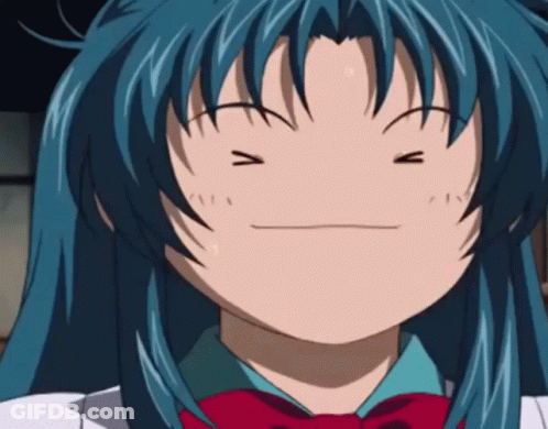 A Girl With Blue Hair Is Making A Funny Face With Her Eyes Closed GIF