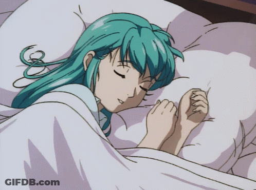 A Girl With Blue Hair Is Sleeping In A Bed With Her Eyes Closed GIF