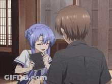 A Girl With Blue Hair Is Talking To A Man GIF