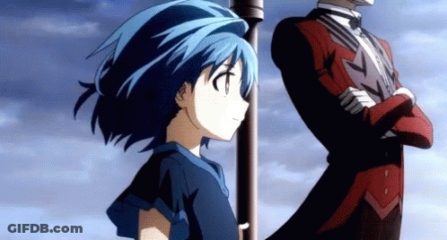A Girl With Blue Hair Stands Next To A Man In A Tuxedo GIF