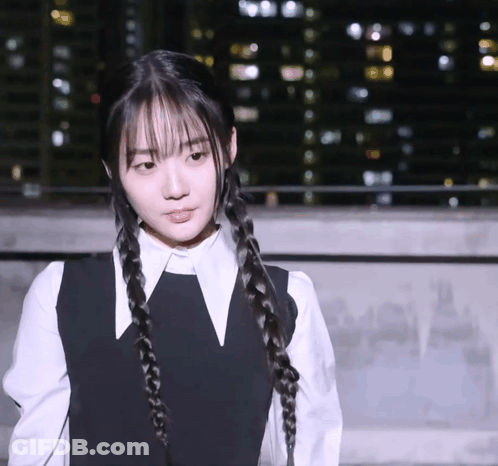 A Girl With Braids And A White Shirt Has A V On Her Collar GIF