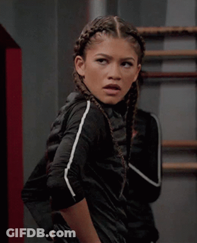 A Girl With Braids In Her Hair Is Wearing A Black Jacket GIF
