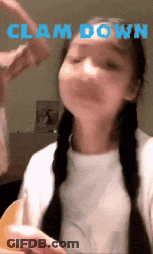 A Girl With Braids Is Making A Face With The Words Clam Down Above Her GIF
