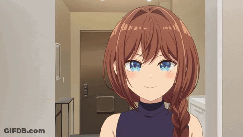 A Girl With Brown Hair And Blue Eyes Is Smiling In A Hallway GIF