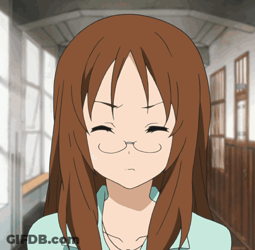 A Girl With Brown Hair And Glasses Is Making A Face GIF