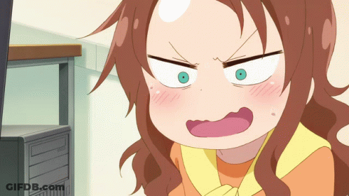 A Girl With Brown Hair And Green Eyes Is Making A Funny Face In Front Of A Computer GIF