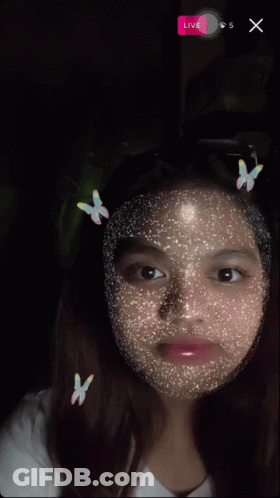 A Girl With Butterflies On Her Face And A Live Button On The Bottom Right GIF