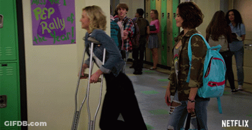 Girl With Crutches Walking Past Netflix Ad GIF
