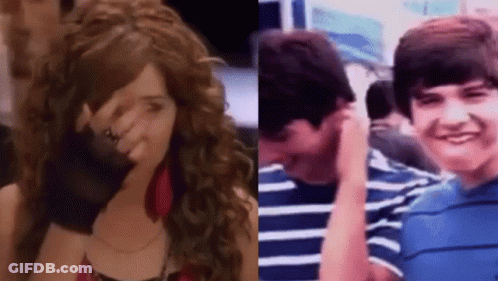 A Girl With Curly Hair Is Covering Her Face Next To A Boy With A Striped Shirt GIF
