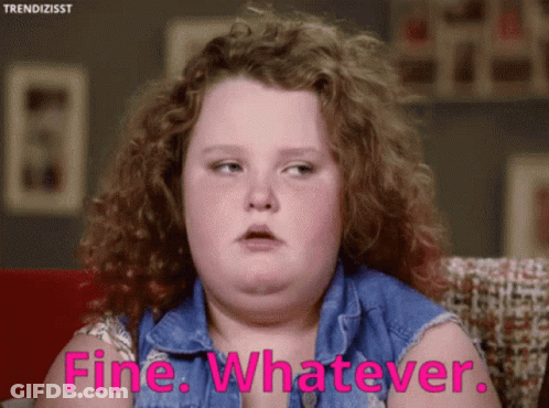 A Girl With Curly Hair Is Sitting On A Couch And Says Fine Whatever GIF