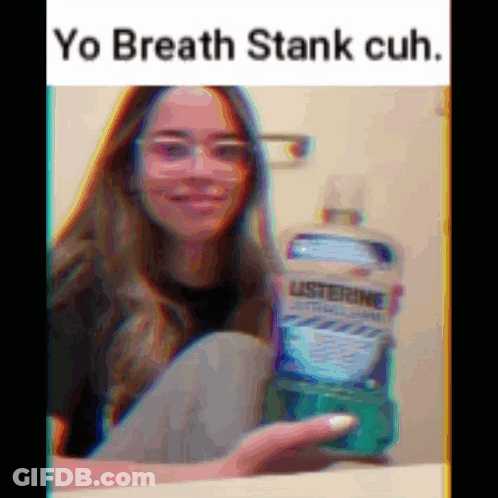 A Girl With Glasses Is Holding A Bottle Of Listerine Mouthwash GIF