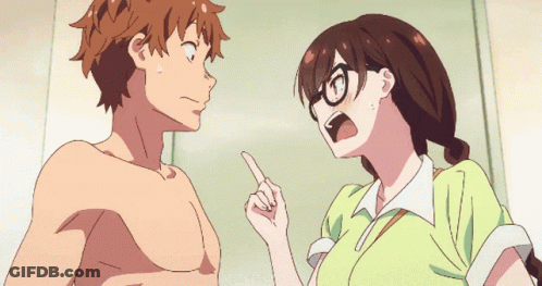 A Girl With Glasses Is Pointing At A Shirtless Guy GIF