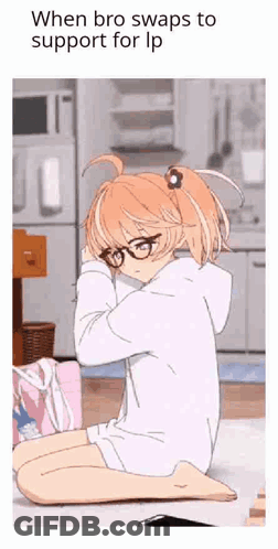 A Girl With Glasses Is Sitting On The Floor With Her Head On Her Knees . GIF