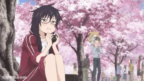 A Girl With Glasses Is Sitting Under A Tree Eating Something GIF