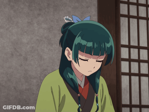 A Girl With Green Hair And Blue Eyes Is Wearing A Green Shirt GIF
