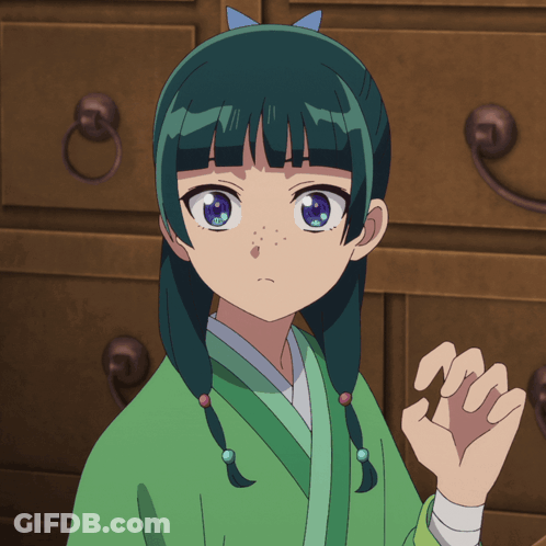 A Girl With Green Hair And Blue Eyes Stands In Front Of A Dresser GIF