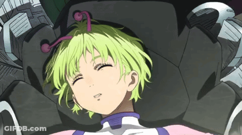 A Girl With Green Hair Is Laying In A Chair GIF