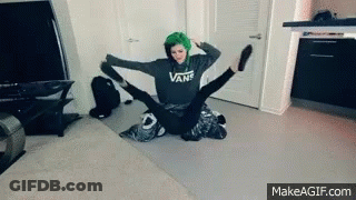 A Girl With Green Hair Is Sitting On A Man 'S Lap With Her Legs Outstretched . GIF