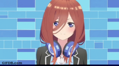 A Girl With Headphones Around Her Neck Is Standing In Front Of A Blue Wall . GIF