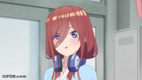 A Girl With Headphones Around Her Neck Is Standing In Front Of A Building . GIF