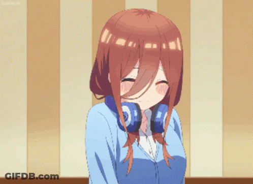 A Girl With Headphones Around Her Neck Makes A Funny Face GIF