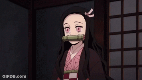 A Girl With Long Black Hair And A Pink Bow In Her Hair Is Standing In A Dark Room GIF