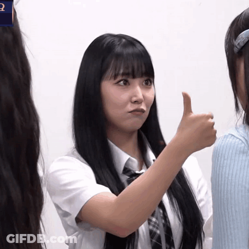A Girl With Long Black Hair Giving A Thumbs Up Sign GIF