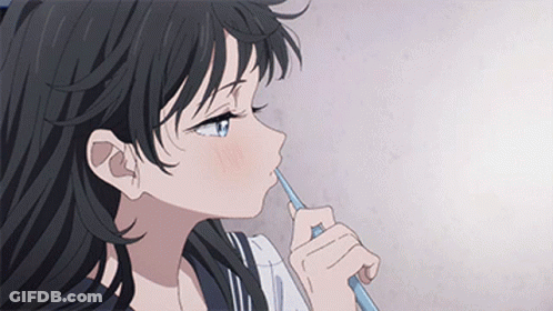 A Girl With Long Black Hair Is Brushing Her Teeth With A Toothbrush . GIF