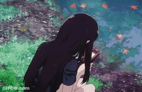 A Girl With Long Black Hair Is Holding A Cell Phone In Her Hand GIF