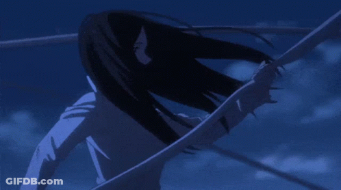 A Girl With Long Black Hair Is Standing In A Dark Room GIF