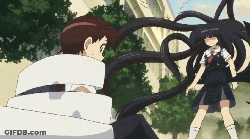 A Girl With Long Black Hair Is Standing Next To A Boy Who Is Wrapped In White Tape GIF