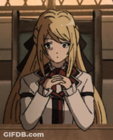 A Girl With Long Blonde Hair Is Sitting At A Desk With Her Hands Folded GIF