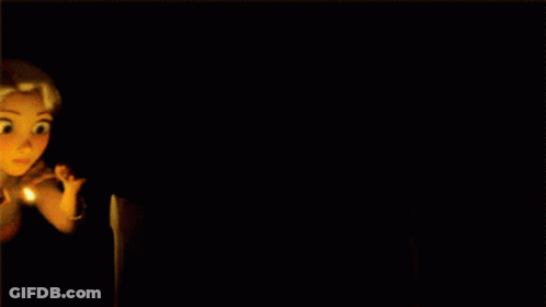 A Girl With Long Blonde Hair Is Surrounded By Candles GIF