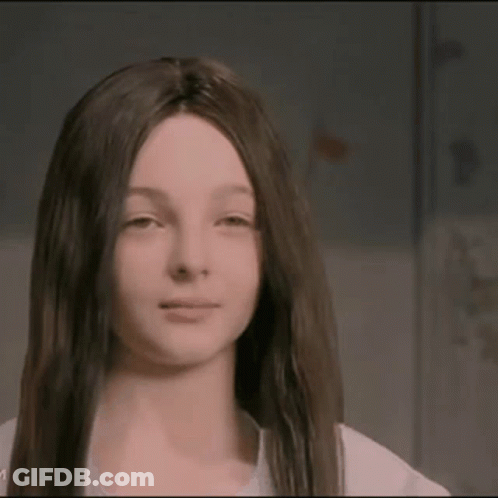 A Girl With Long Dark Hair Is Wearing A Wig GIF