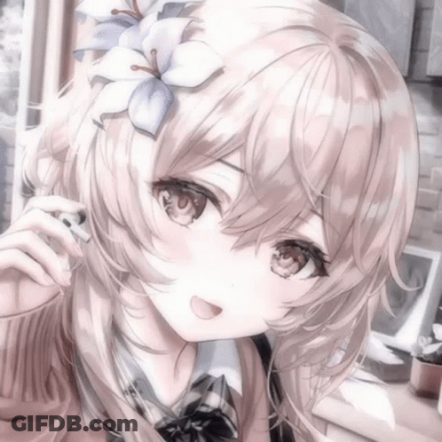 A Girl With Long Hair And A Flower In Her Hair Is Smiling . GIF