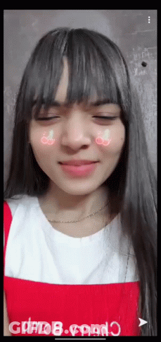 A Girl With Long Hair And Bangs Is Wearing A Red Apron GIF