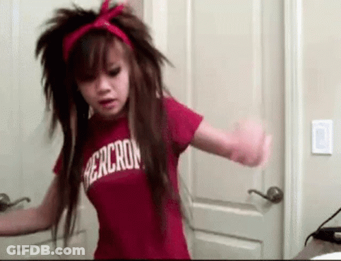 A Girl With Long Hair Is Wearing A Red Shirt That Says Abercrombie . GIF